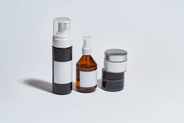 Cosmetological bottles for daily care with empty labels - Foto, imagen