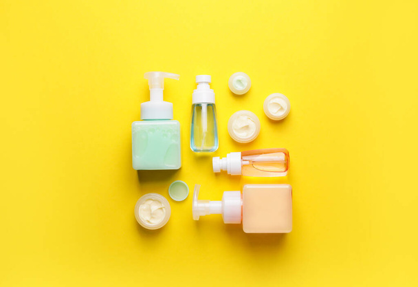 Bottles with different cosmetic products on color background - Photo, Image