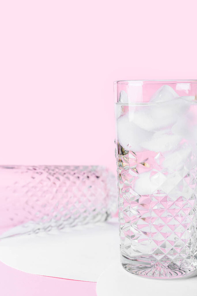 Glasses of water with ice cubes on color background - Fotó, kép