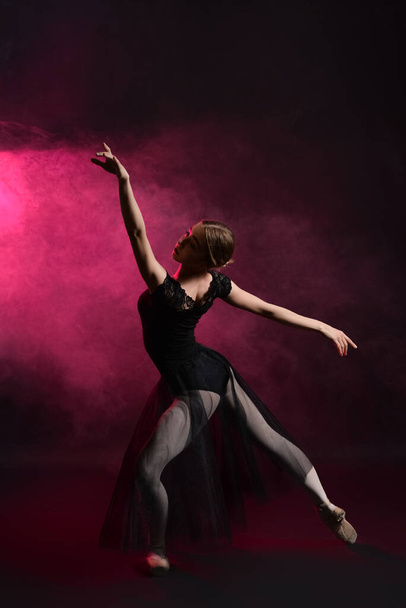 Beautiful young ballerina on dark color background - Foto, imagen