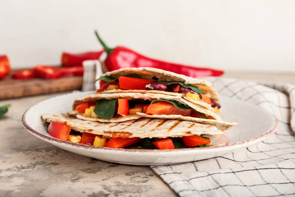 Plate with tasty vegetarian quesadillas on table - Фото, зображення