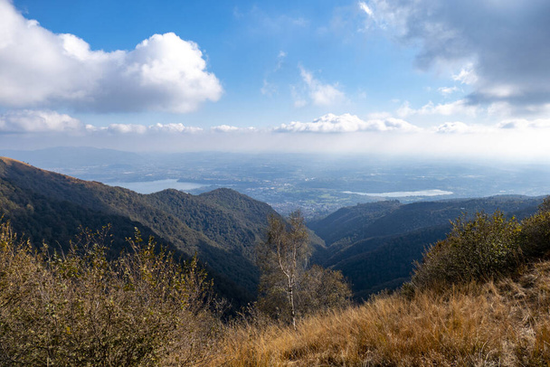 A scenic shot of mountain field overlooking the mountain valleys under a beautiful cloudscape - Fotó, kép