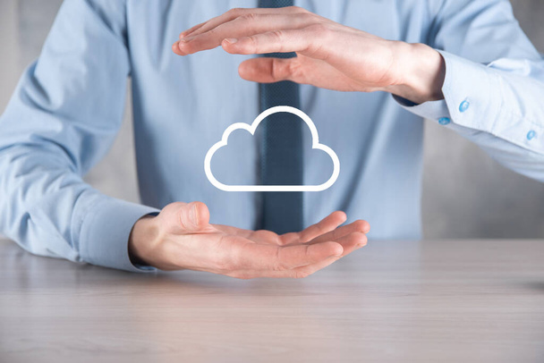 Businessman hand holding cloud.Cloud computing concept, close up of young business man with cloud over his hand.The concept of cloud service - Photo, Image