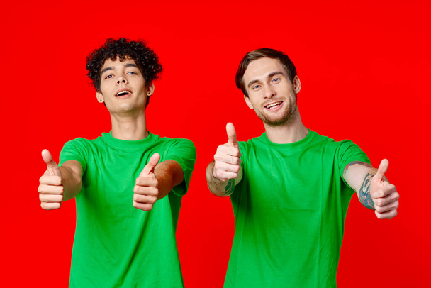 two man holding his neck emotions discontent red background - Photo, Image