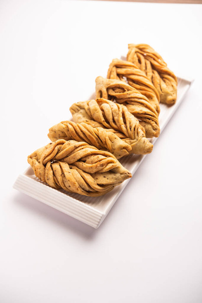 Leaf shape or laccha Mathri or mathiya is a Rajasthani tea time snack. It's a fried flaky biscuit from the north-west region of India - Photo, Image