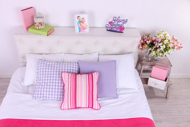 Comfortable soft bed in room - Valokuva, kuva
