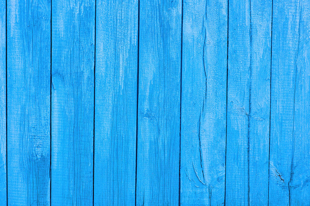 Old blue wooden wall of a house with cracked oil paint. Bright colorful vintage wood background - Foto, afbeelding