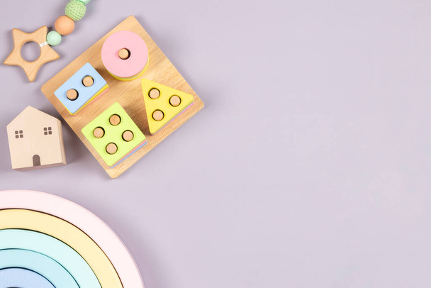 Baby kid toys on light gray background. Sustainable early childhood development baby stuff and natural pastel color wooden toys. Top view, flat lay - Photo, Image
