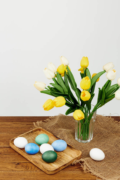 colorful eggs on a tray Yellow flowers holiday Easter - Foto, Bild