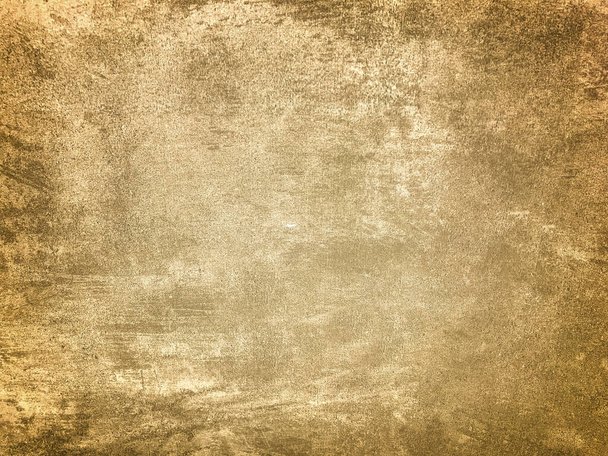 Tekstuuri koriste vaalean beige kipsi jäljittelemällä vanha kuorinta seinään tumma vinjetti. Vanhentunut säröillä kultainen kivi tausta kaltevuus. Rakenne ruskea sementti seinään. - Valokuva, kuva