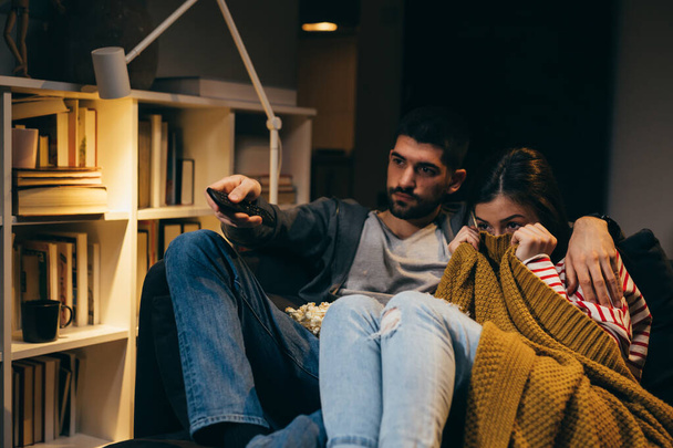 young couple watching television together at home - Photo, Image