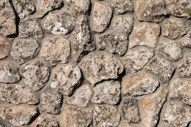 Decorative wall made of natural stone of various shapes and sizes. Interior background - Photo, image