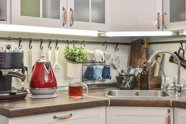 Red electric kettle in retro stile with coffee machine in kitchen interior  - Fotoğraf, Görsel
