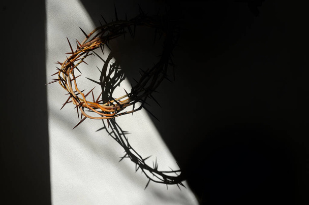 Abstract Easter. Crown of thorns and swadow on wall - Photo, Image
