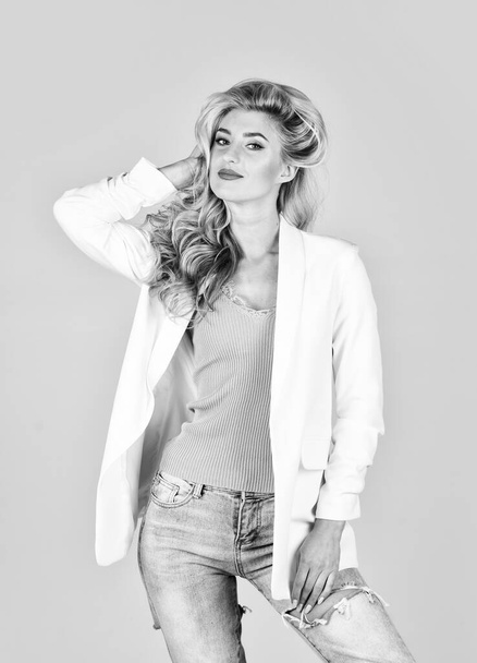 Young and carefree. elegant in any style. sexy girl has long blond curly hair. trendy makeup concept. hairdresser beauty salon. pure female. fashion and beauty. attractive woman wear jacket - 写真・画像