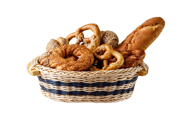 Fresh baked crispy bread, french baguette, turkish sesame bagel and german salty and with sesame pretzel  buns in the basket isolated on white  background with a copy space - Photo, Image