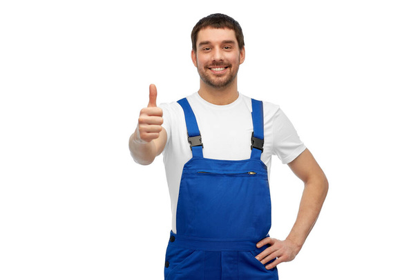 happy male worker or builder showing thumbs up - Fotó, kép