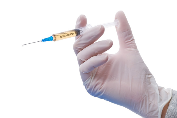 Syringe in hand on white  - Photo, Image