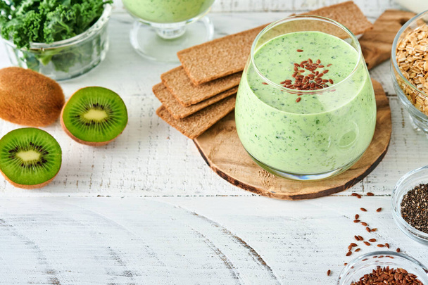 Detox green smoothie with kale, spinach and kiwi on a light gray slate, stone or concrete background. Top view with copy space. - Zdjęcie, obraz
