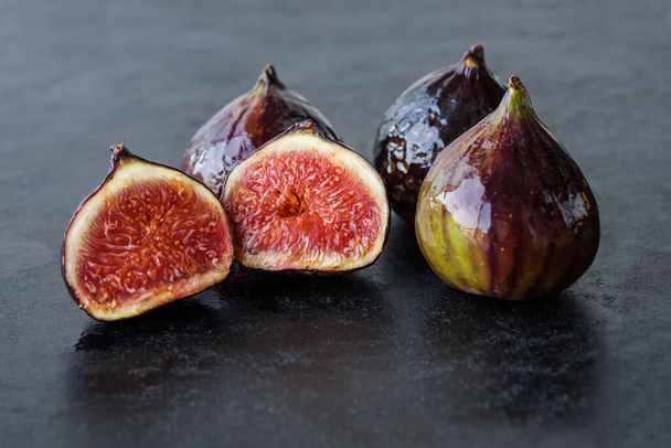 A few ripe figs on an old wooden background. Seasonal fruits. - Fotó, kép