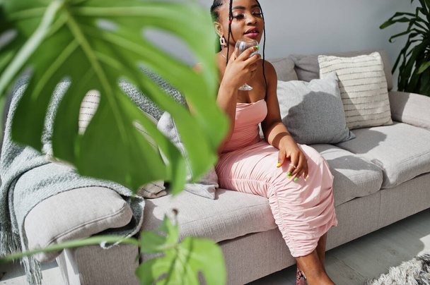 Fashionable photo of young beautiful romantic african american woman with glass of wine, wearing pink dress. Summer, spring style. - Foto, imagen