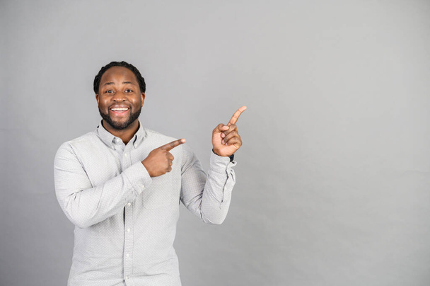 African-American man points finger up isolated on grey - Valokuva, kuva
