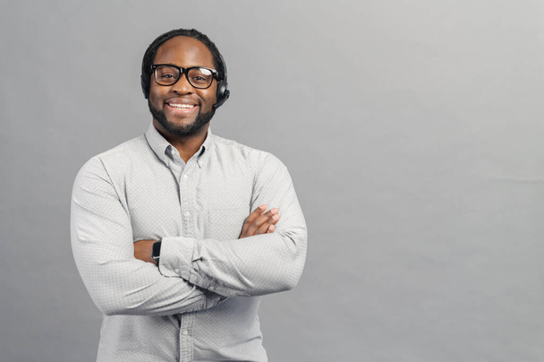 Smiling African-American man wearing headset isolated on grey - Valokuva, kuva