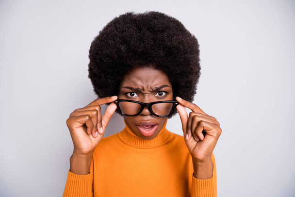 Photo portrait of confused black skin woman taking off glasses isolated on clear grey colored background - Foto, imagen