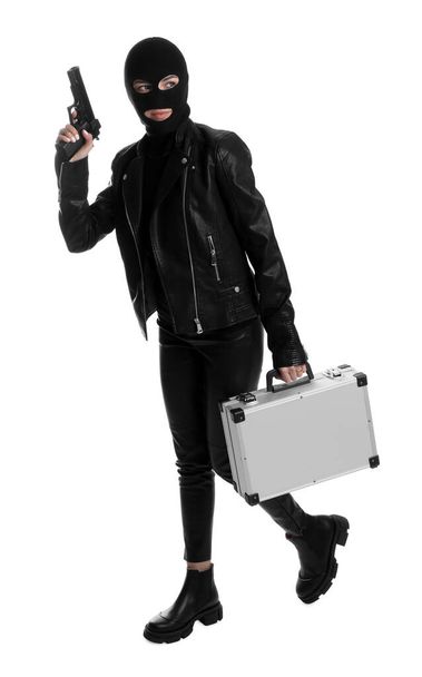 Woman wearing knitted balaclava with metal briefcase and gun on white background - Valokuva, kuva