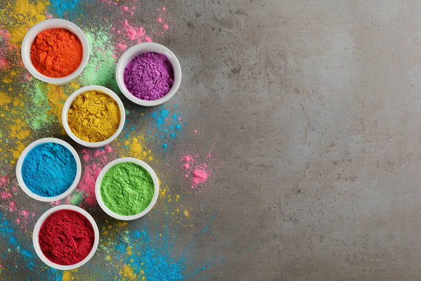 Colorful powder dyes on grey background, flat lay with space for text. Holi festival - Фото, зображення