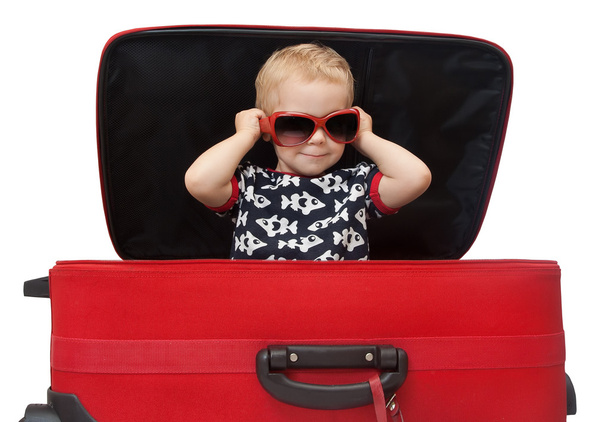 Little kid in sunglasses looking out red suitcase - Φωτογραφία, εικόνα