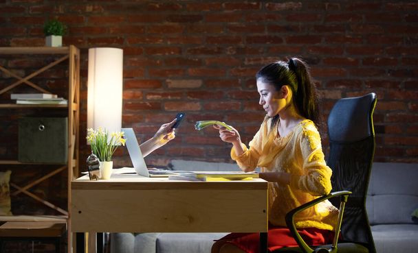 Young Caucasian woman using online banking through laptop. - Valokuva, kuva