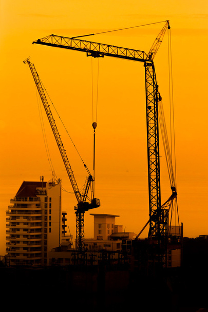 Industrial construction cranes and building silhouettes - Photo, Image