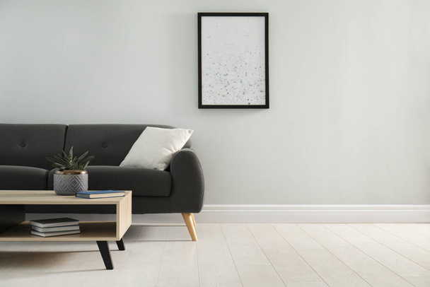 Stylish living room interior with comfortable grey sofa and beautiful plant - Photo, Image