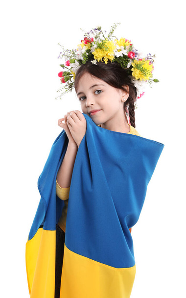 Little girl in flower wreath with flag of Ukraine on white background - Zdjęcie, obraz