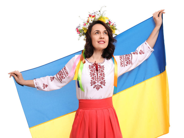 Happy woman in national clothes with flag of Ukraine on white background - Photo, Image