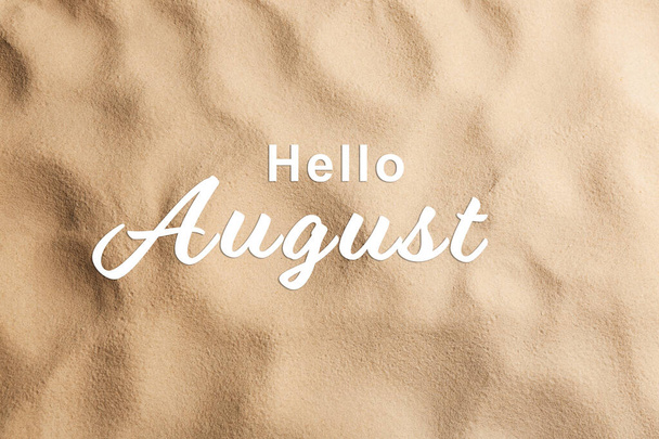 Hello August. Beach sand as background, top view - Zdjęcie, obraz
