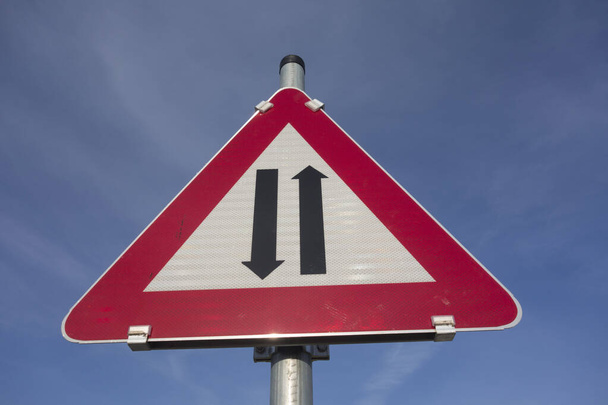 uwaga dwukierunkowy ruch drogowy lub nadjeżdżający znak drogowy, czerwony trójkąt jako ostrzeżenie - Zdjęcie, obraz