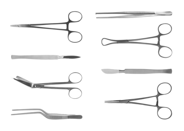 Set with different surgical instruments on white background - Photo, image