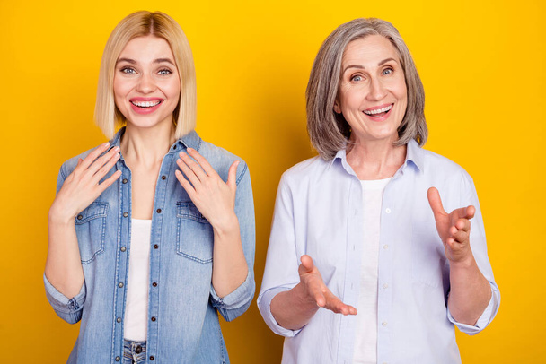 Photo portrait of mother and daughter talking communicating smiling isolated bright yellow color background - Fotografie, Obrázek
