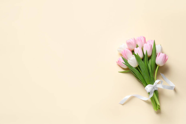 Beautiful pink spring tulips on beige background, top view. Space for text - Fotografie, Obrázek