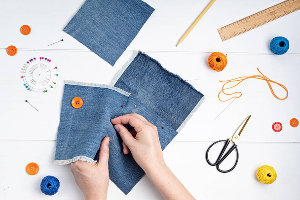 Old jeans upcycling idea. Crafting with denim, recycling old clothers, hobby, diy activity - Photo, Image