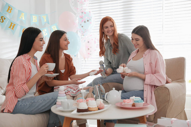 Happy pregnant woman spending time with friends at baby shower party - 写真・画像