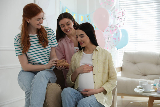 Happy pregnant woman spending time with friends at baby shower party - Photo, image