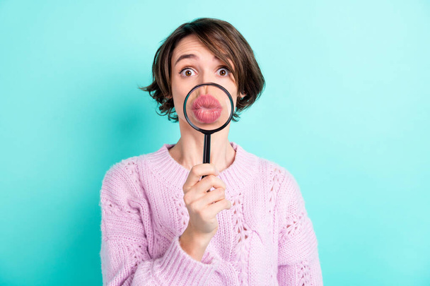 Photo of sweet funny young woman wear violet sweater enlarging loupe pouted lips isolated turquoise color background - 写真・画像