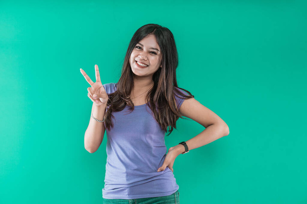 young pretty Asian woman smiling and giving the peace sign - Zdjęcie, obraz