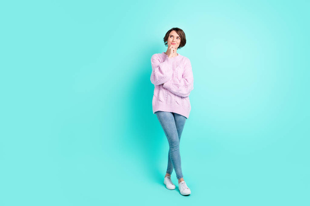 Full length photo of sweet thoughtful woman wear violet sweater arm chin looking empty space isolated turquoise color background - Фото, изображение