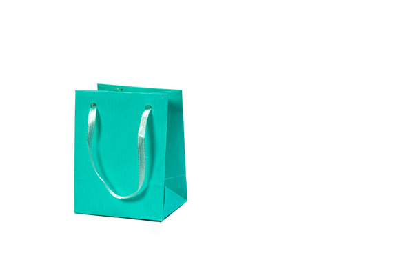 light green paper shopping bag isolated on light background, mockup for design - Foto, Imagem