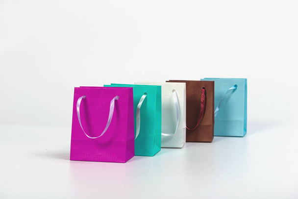 many colourful paper shopping bags isolated on white background, mockup for design - Foto, immagini