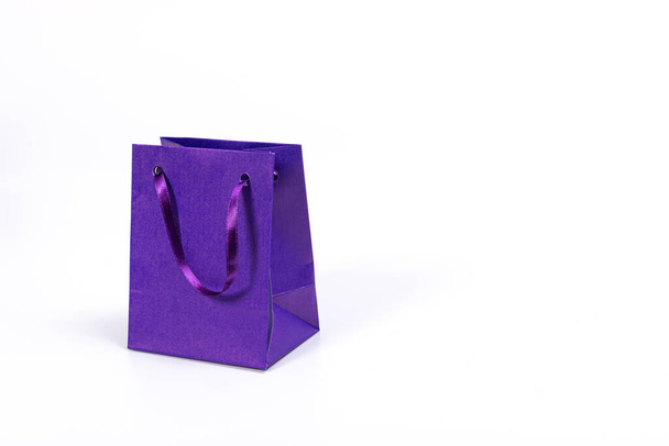 blue paper shopping bag isolated on light background, mockup for design - Φωτογραφία, εικόνα